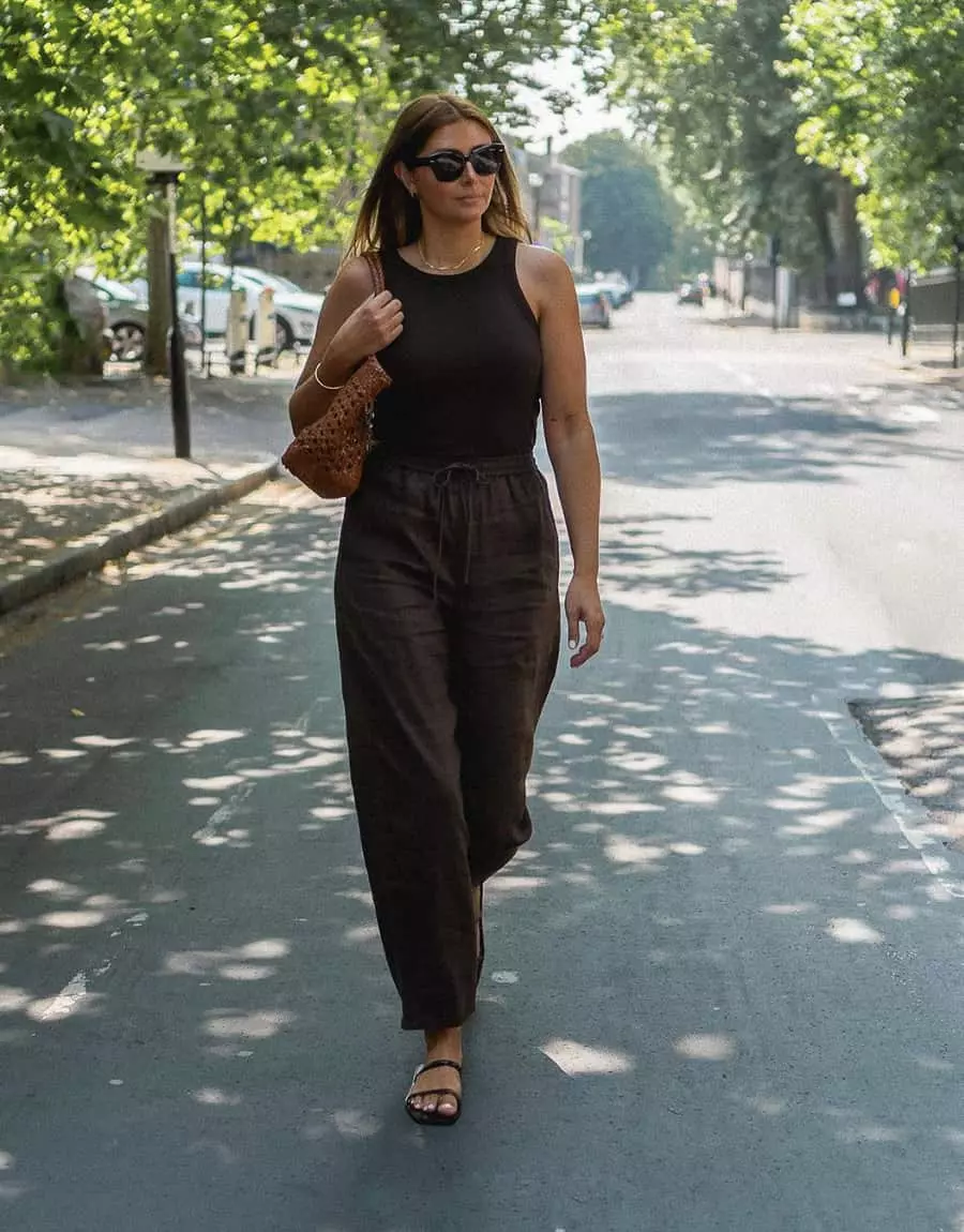 woman wearing a brown tank top with brown linen pants and brown sandals