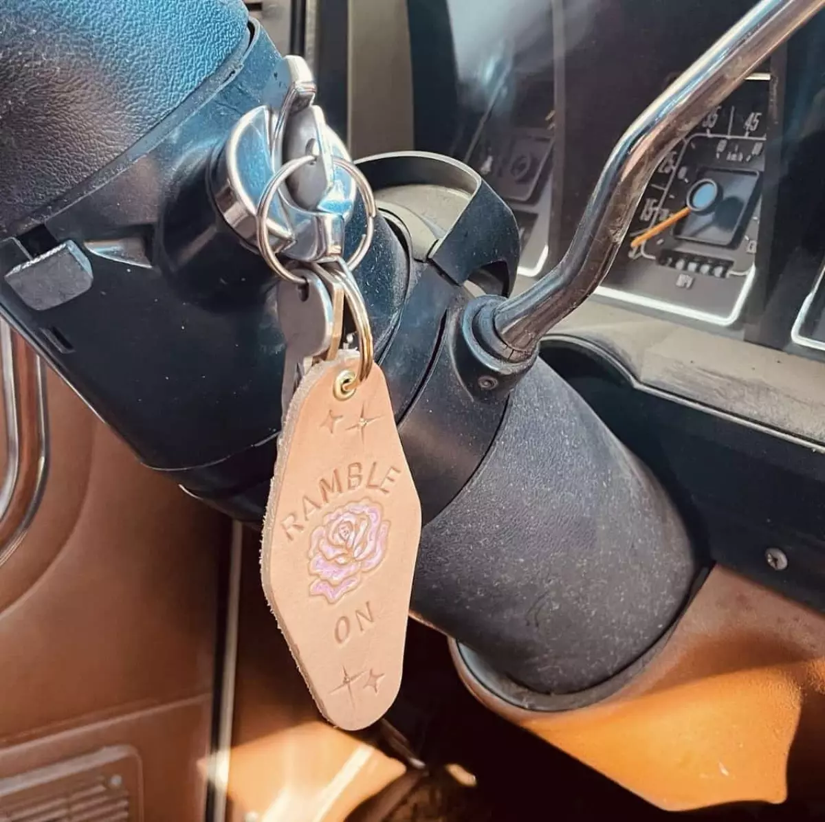 keys in with a key chain in an ignition