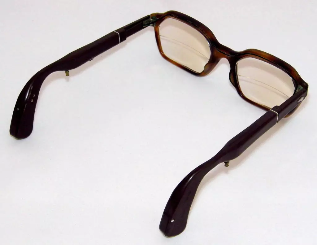 A pair of tortoiseshell glasses against an ivory-colored background.