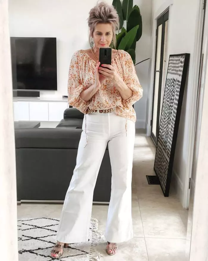 White flare jeans look great with a tucked-in blouse